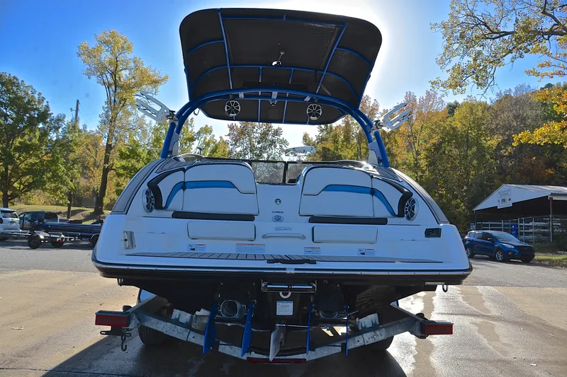 Slide: The Image of 2018 Yamaha Boats 242X on trailer, rear view, outdoors with autumn trees. - 13