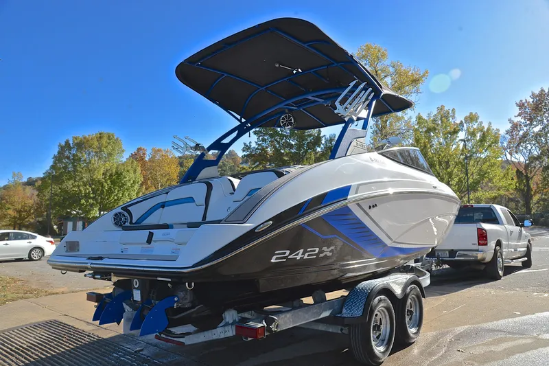 Slide: The Image of 2018 Yamaha Boats 242X on trailer, sleek design, parked outdoors. - 14