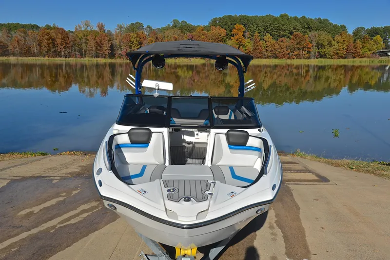 Slide: The Image of 2018 Yamaha Boats 242X on a serene lake with autumn foliage backdrop. - 17