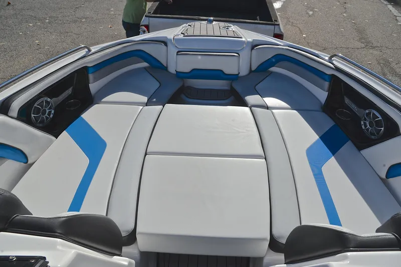 Slide: The Image of 2018 Yamaha Boats 242X interior with blue and white seating, featuring built-in speakers. - 21