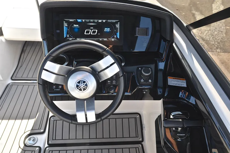 Slide: The Image of 2018 Yamaha Boats 242X dashboard with steering wheel and digital display. - 26