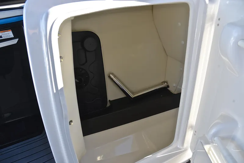 Slide: The Image of Storage compartment inside a 2018 Yamaha Boats 242X, featuring a sleek interior design. - 27