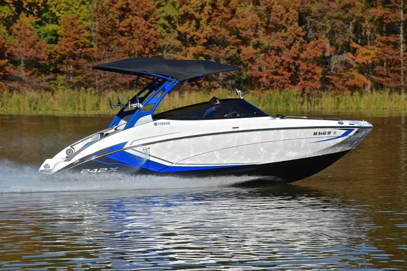 Slide: The Image of 2018 Yamaha Boats 242X speeding on a lake with autumn foliage background. - 3