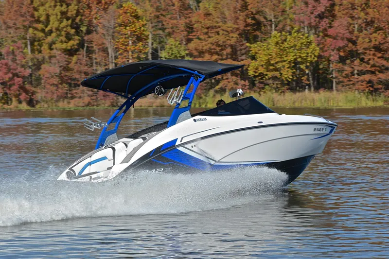Slide: The Image of 2018 Yamaha Boats 242X speeding on a lake with autumn trees in the background. - 5