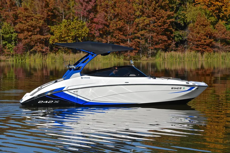 Slide: The Image of 2018 Yamaha Boats 242X on a serene lake with autumn foliage backdrop. - 7