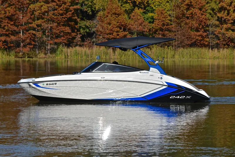 Slide: The Image of 2018 Yamaha Boats 242X on calm lake with autumn trees in background. - 9