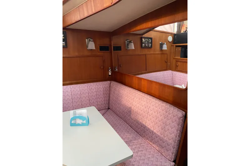 Slide: The Image of Interior of 1986 Chris-Craft 426 Catalina with pink seating and wooden paneling. - 11