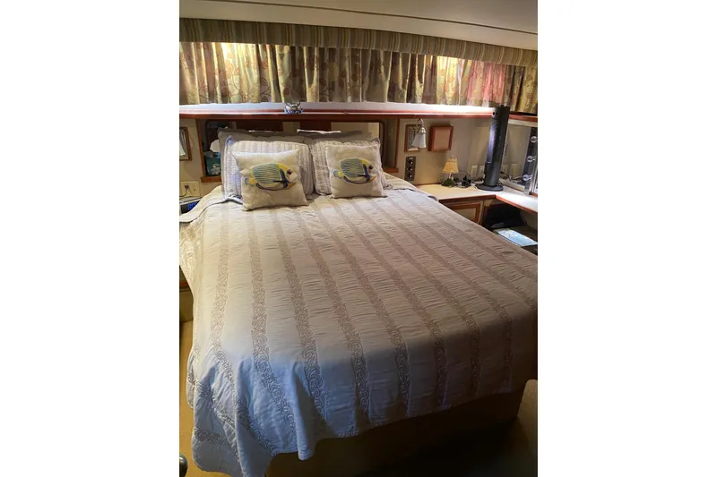 Slide: The Image of Cozy bedroom interior of 1986 Chris-Craft 426 Catalina yacht with decorative pillows. - 18