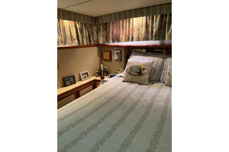 Slide: The Image of Cozy bedroom interior of 1986 Chris-Craft 426 Catalina yacht with decorative pillows. - 19
