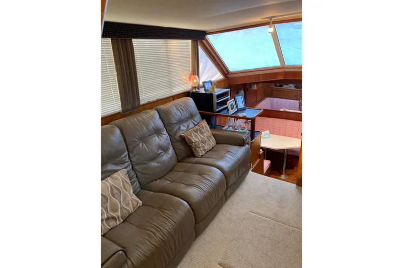 Slide: The Image of Interior of 1986 Chris-Craft 426 Catalina yacht with leather seating and dining area. - 2