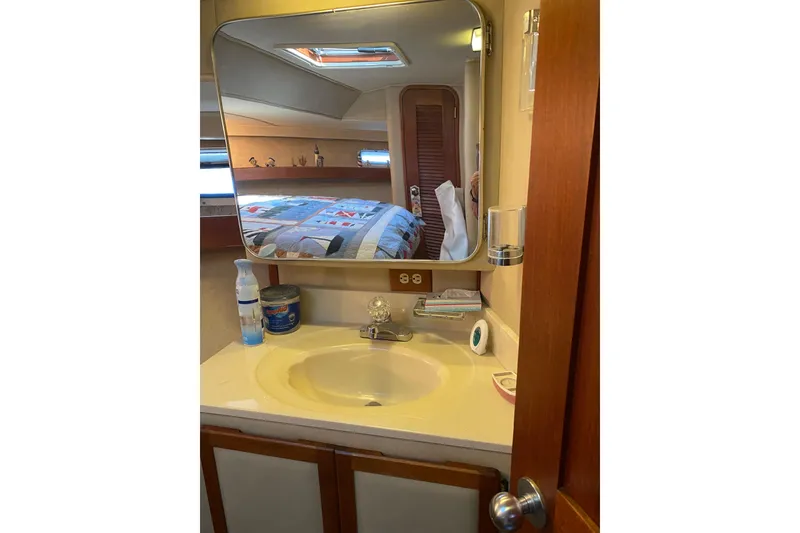 Slide: The Image of Bathroom vanity in 1986 Chris-Craft 426 Catalina yacht with mirror and sink. - 27