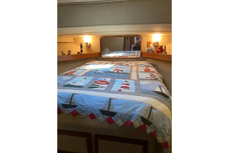 Slide: The Image of Cozy cabin interior of 1986 Chris-Craft 426 Catalina with nautical-themed quilt. - 28