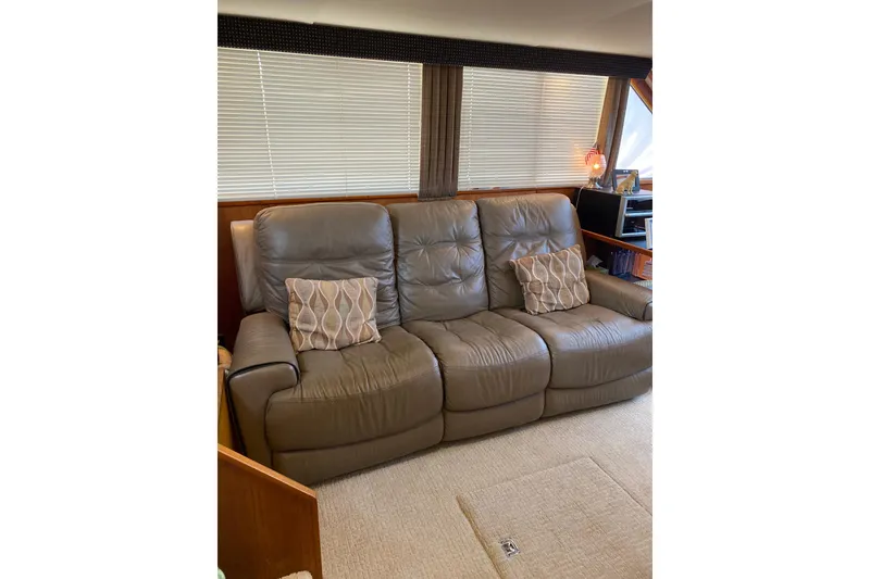 Slide: The Image of Luxurious leather sofa inside 1986 Chris-Craft 426 Catalina yacht, featuring decorative pillows. - 3