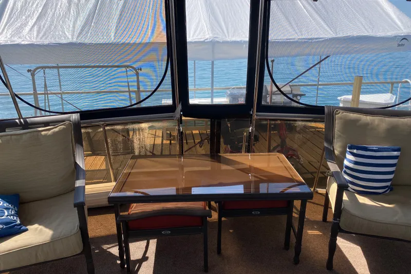 Slide: The Image of Interior view of 1986 Chris-Craft 426 Catalina yacht with seating and table. - 30