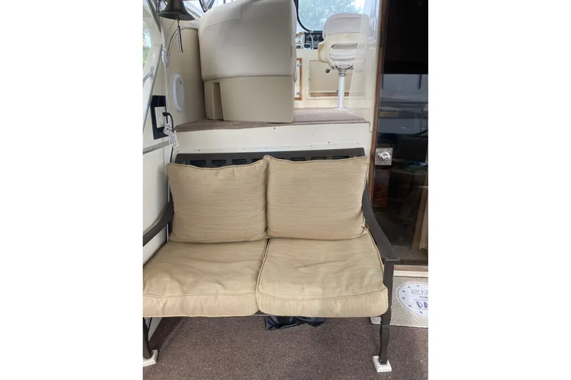 Slide: The Image of 1986 Chris-Craft 426 Catalina interior with beige cushioned seating and helm area. - 32