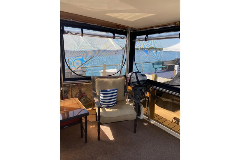 Slide: The Image of Interior of 1986 Chris-Craft 426 Catalina with lake view and striped cushion. - 33