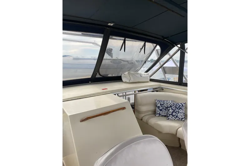 Slide: The Image of 1986 Chris-Craft 426 Catalina interior with seating and decorative pillows. - 34