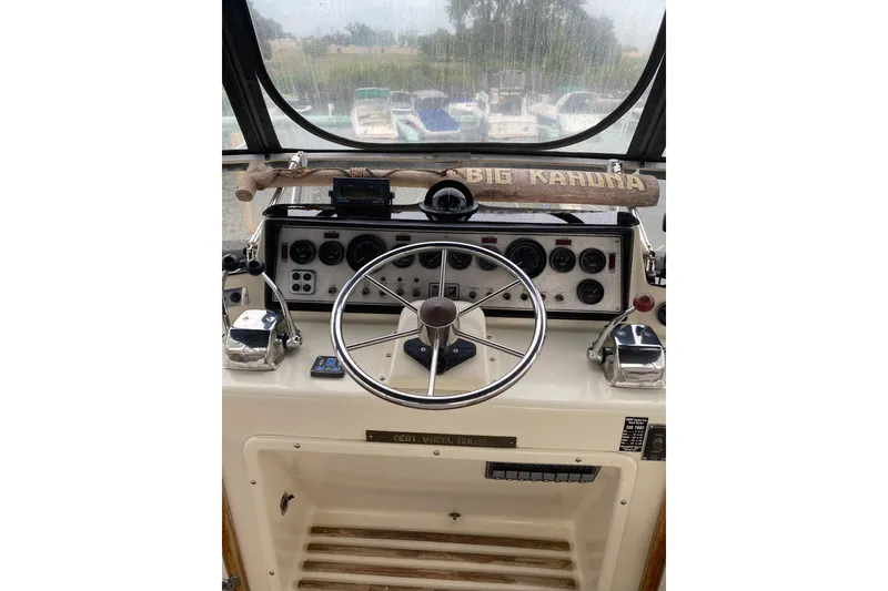 Slide: The Image of 1986 Chris-Craft 426 Catalina helm with steering wheel and control panel. - 35