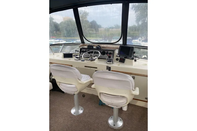 Slide: The Image of Interior helm of 1986 Chris-Craft 426 Catalina with dual white captain chairs. - 36