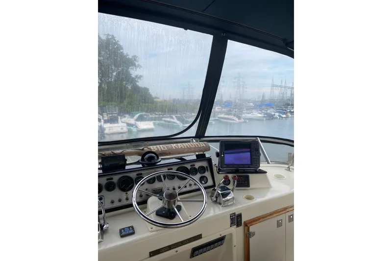 Slide: The Image of Helm of 1986 Chris-Craft 426 Catalina with marina view through windshield. - 37