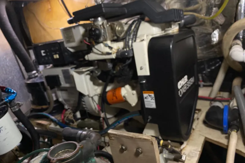 Slide: The Image of Engine room of 1986 Chris-Craft 426 Catalina with Onan generator and various mechanical components. - 40