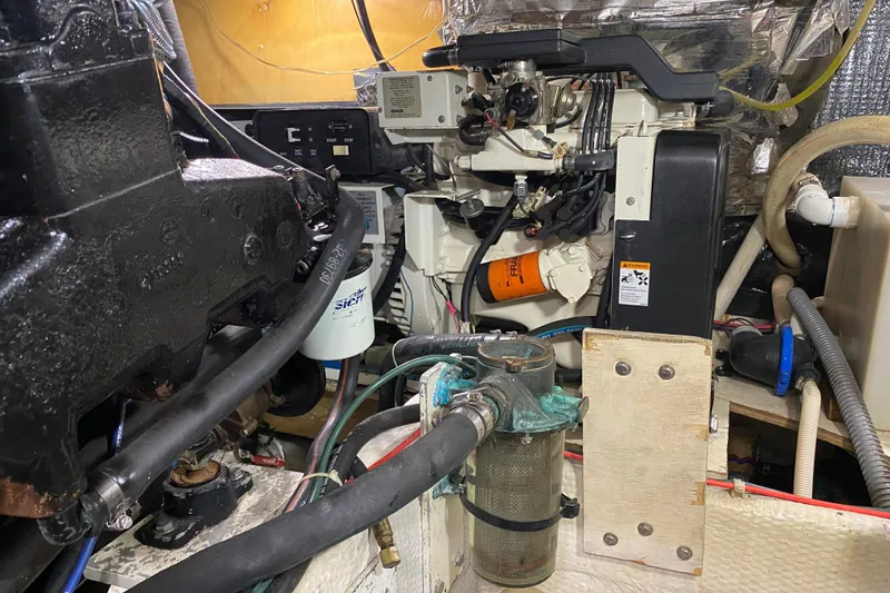 Slide: The Image of Engine room of 1986 Chris-Craft 426 Catalina, showcasing mechanical components and wiring. - 41