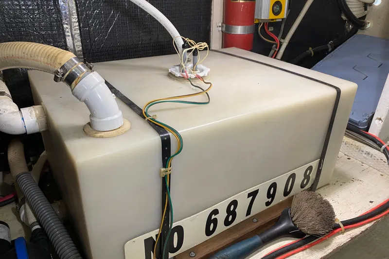 Slide: The Image of 1986 Chris-Craft 426 Catalina engine room with storage tank and wiring. - 43