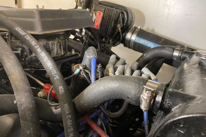 Slide: The Image of Engine components of a 1986 Chris-Craft 426 Catalina boat, featuring hoses and wiring. - 47
