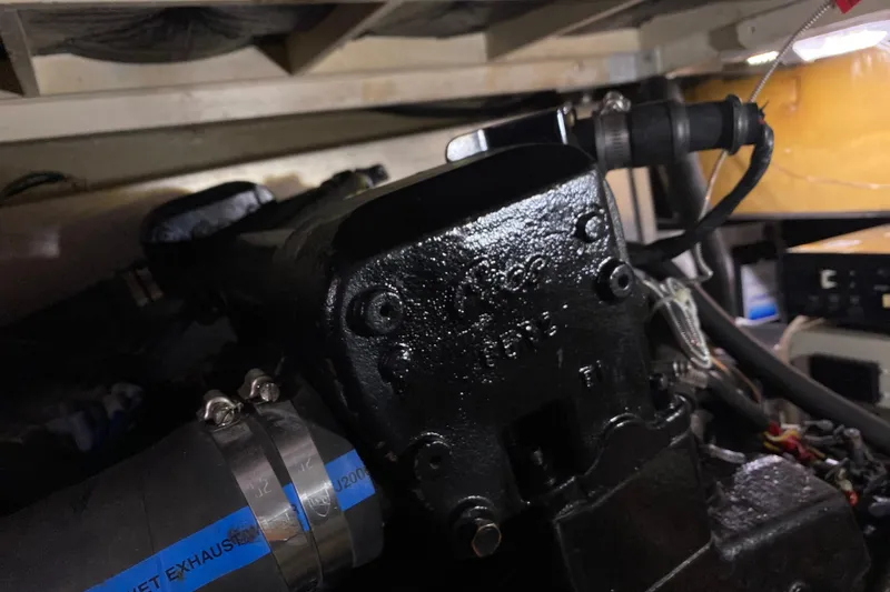 Slide: The Image of Engine compartment of a 1986 Chris-Craft 426 Catalina boat, showcasing mechanical components. - 49