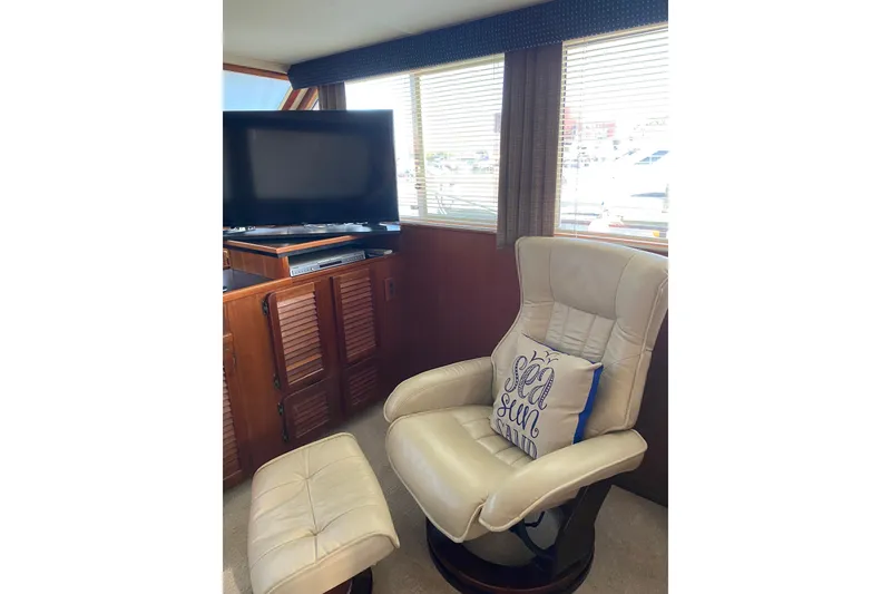 Slide: The Image of Interior of 1986 Chris-Craft 426 Catalina with leather chair, TV, and nautical decor. - 5