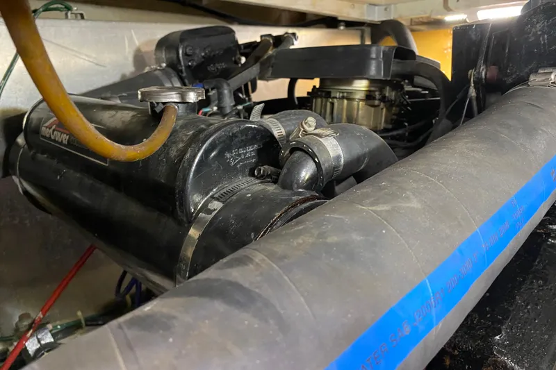 Slide: The Image of Engine compartment of 1986 Chris-Craft 426 Catalina with visible hoses and components. - 51