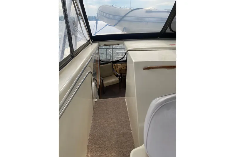 Slide: The Image of Interior view of 1986 Chris-Craft 426 Catalina yacht with seating and windows. - 53