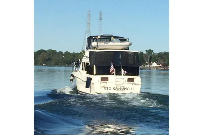 Slide: The Image of 1986 Chris-Craft 426 Catalina yacht cruising on a calm lake, rear view. - 55