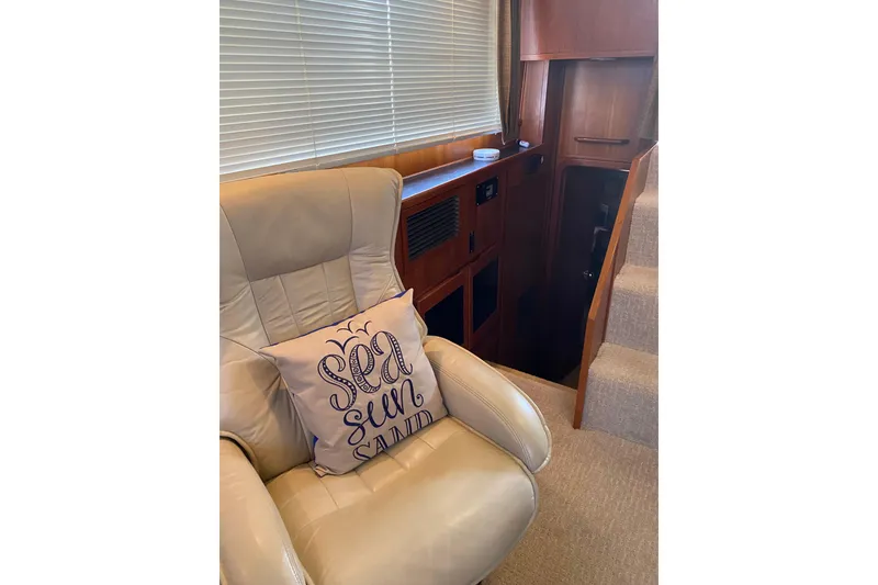 Slide: The Image of Interior of 1986 Chris-Craft 426 Catalina with beige chair and nautical-themed pillow. - 6