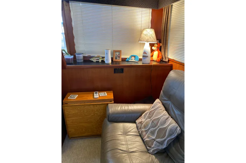 Slide: The Image of Cozy interior of 1986 Chris-Craft 426 Catalina with leather chair and decorative lamp. - 8