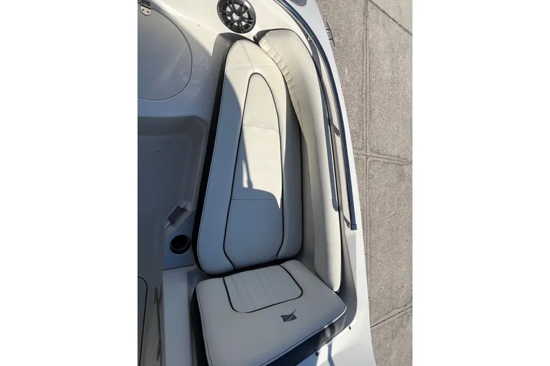 Slide: The Image of 2020 Stingray 201DS boat interior with white cushioned seating and speaker. - 12