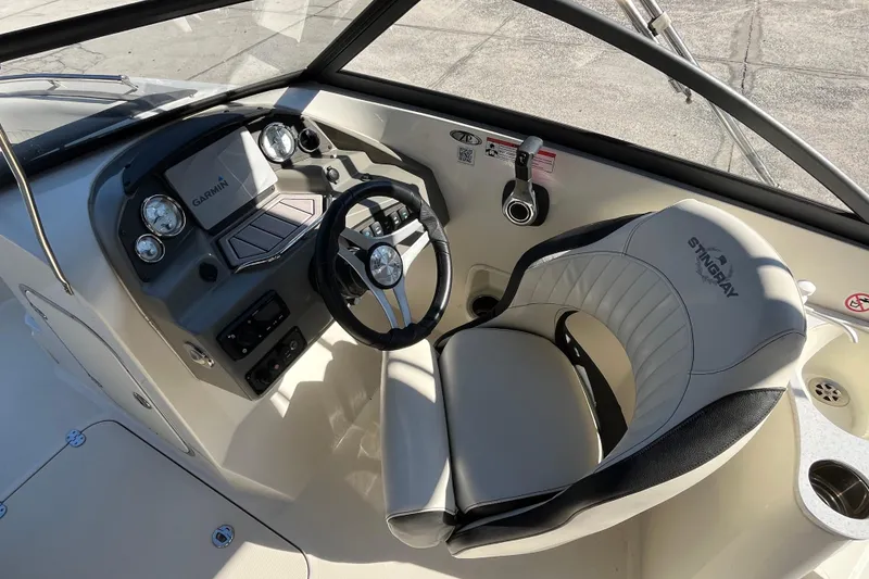 Slide: The Image of 2020 Stingray 201DS boat cockpit with steering wheel and Garmin display. - 13