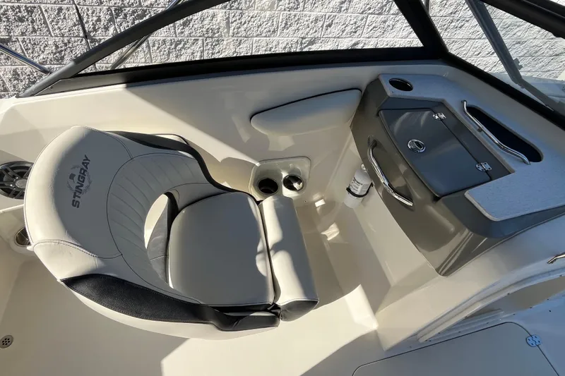 Slide: The Image of 2020 Stingray 201DS boat interior with seating and storage compartment. - 14