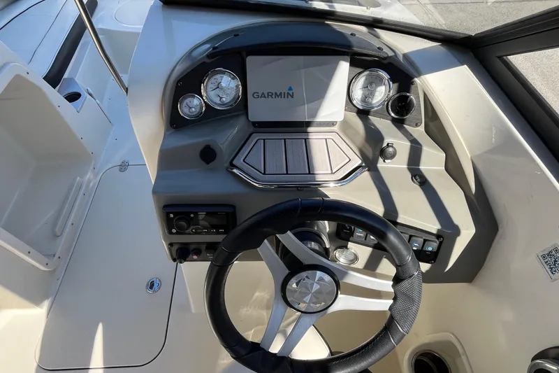 Slide: The Image of 2020 Stingray 201DS boat dashboard with Garmin navigation system and steering wheel. - 16