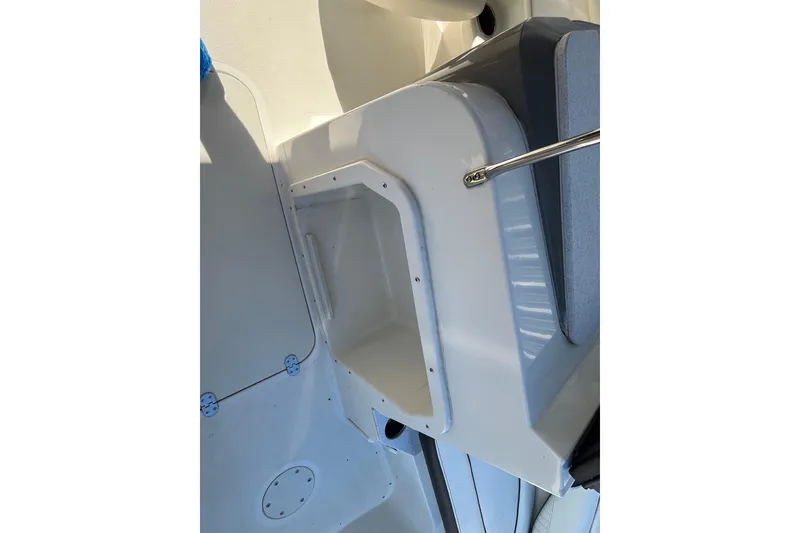 Slide: The Image of 2020 Stingray 201DS boat interior detail, featuring storage compartment and seating area. - 17