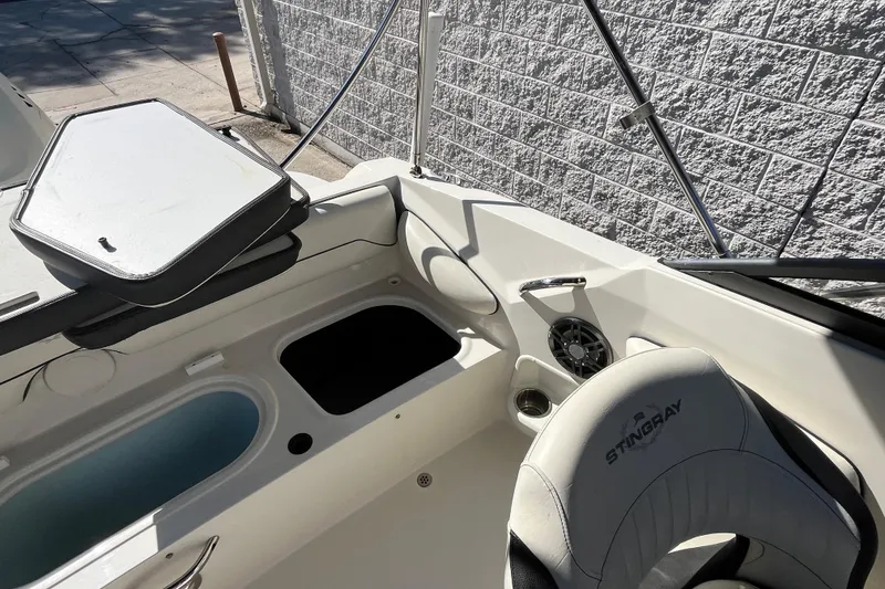 Slide: The Image of Interior of a 2020 Stingray 201DS boat, featuring seating and storage compartments. - 21