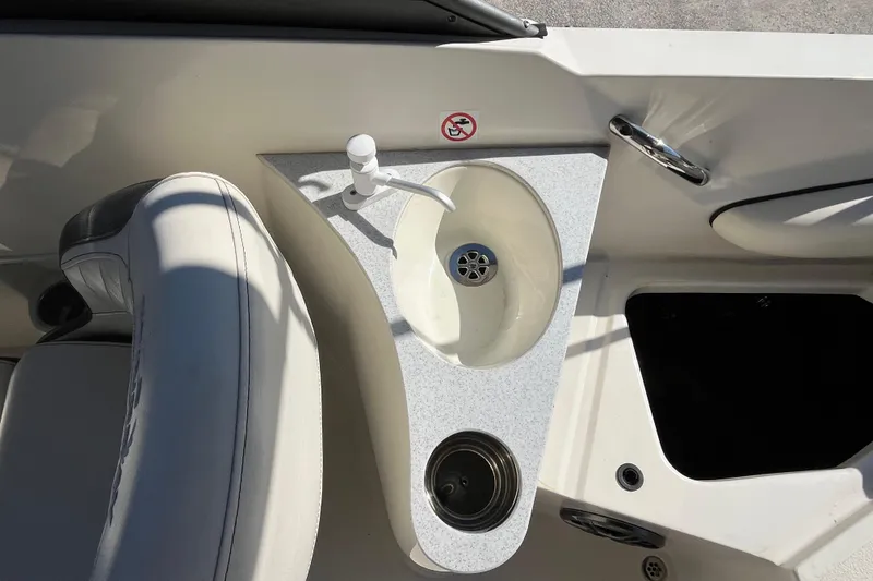 Slide: The Image of 2020 Stingray 201DS boat interior with sink and seating area. - 24
