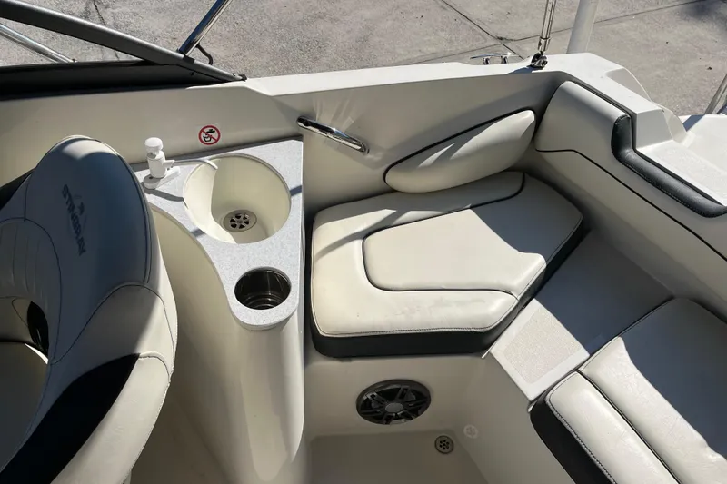 Slide: The Image of 2020 Stingray 201DS boat interior with seating, cup holders, and sink. - 25