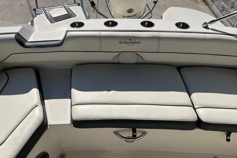 Slide: The Image of 2020 Stingray 201DS boat interior with cushioned seating and cup holders. - 26