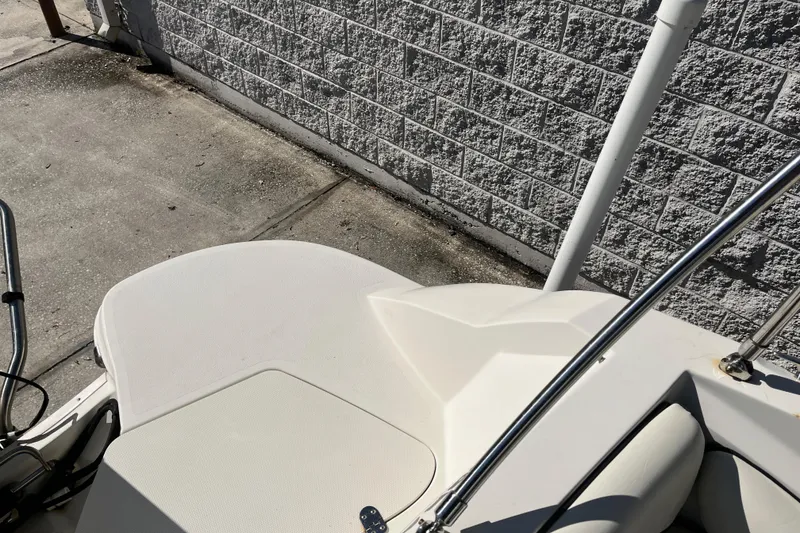 Slide: The Image of 2020 Stingray 201DS boat deck near a textured brick wall. - 30