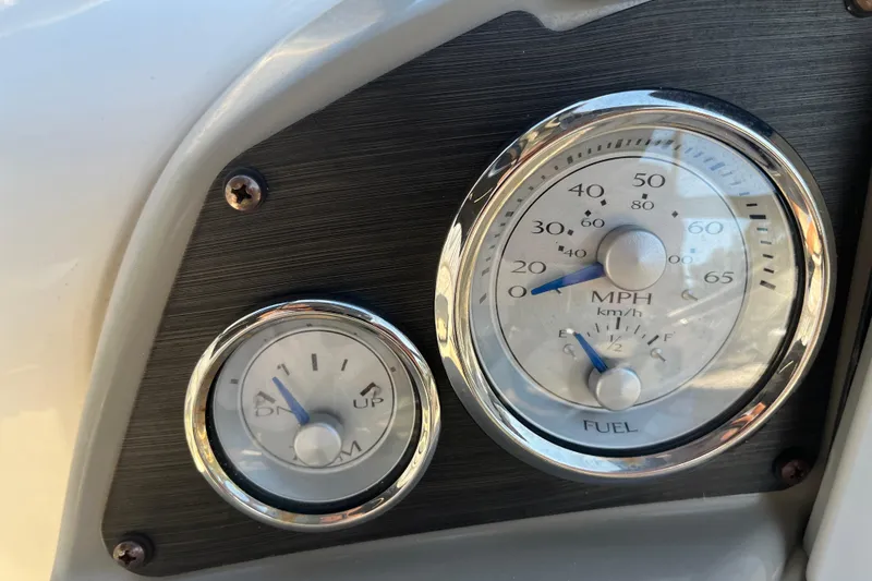 Slide: The Image of Dashboard gauges of a 2020 Stingray 201DS boat, showing speed and fuel levels. - 32