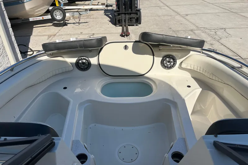 Slide: The Image of 2020 Stingray 201DS boat interior with seating and storage compartments. - 6