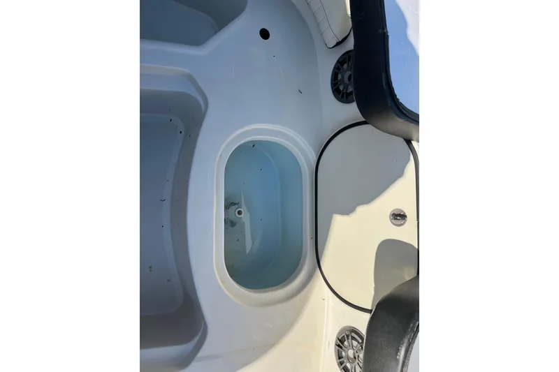 Slide: The Image of Interior view of a 2020 Stingray 201DS boat, featuring seating and storage compartments. - 8