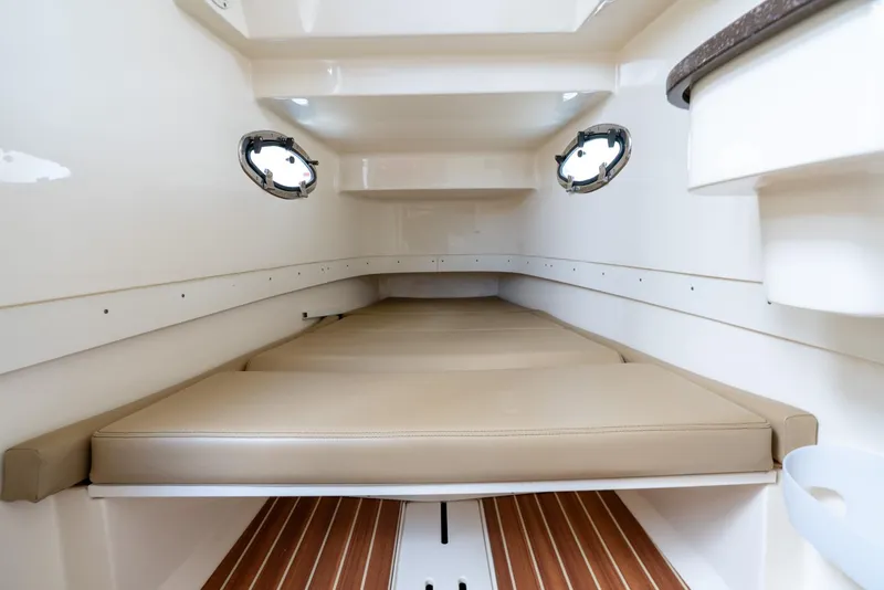 Slide: The Image of 2015 Scout 300 LXF cabin interior with beige cushions and wood flooring. - 26