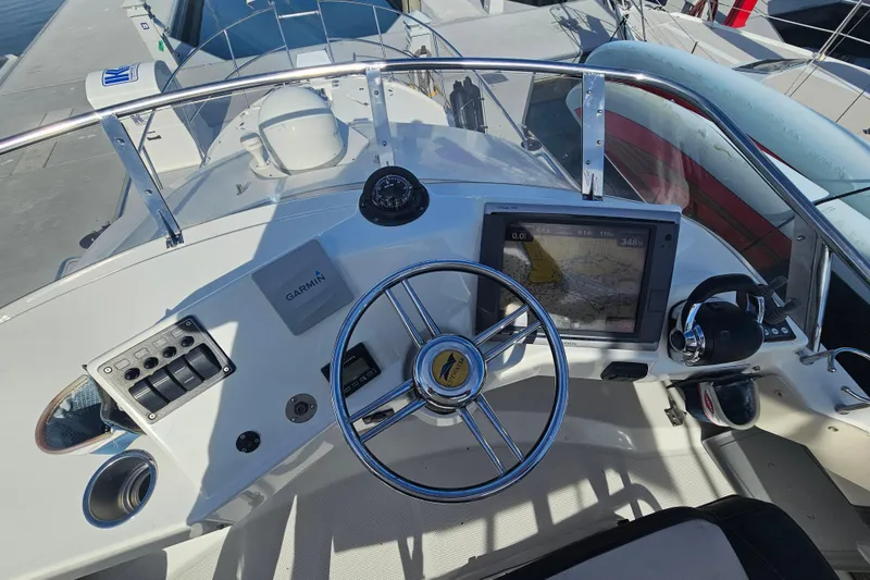 Slide: The Image of 2015 Cutwater 30 Command Bridge helm with Garmin navigation system and steering wheel. - 10